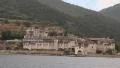 Ship sails along peninsula of Athos, autonomous monastic state in Greece HD Footage
