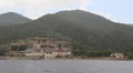 Ship sails along peninsula of Athos, autonomous monastic state in Greece HD Footage