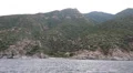 Ship sails along peninsula of Athos, autonomous monastic state in Greece HD Footage