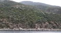 Ship sails along peninsula of Athos, autonomous monastic state in Greece HD Footage