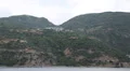 Ship sails along peninsula of Athos, autonomous monastic state in Greece HD Footage