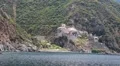 Ship sails along peninsula of Athos, autonomous monastic state in Greece HD Footage