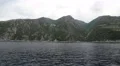 Ship sails along peninsula of Athos, autonomous monastic state, Greece HD Footage