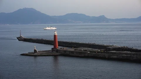 Ship sails behind lighthouse at Port of Naples - MedShot- 8K Stock Footage 294158401