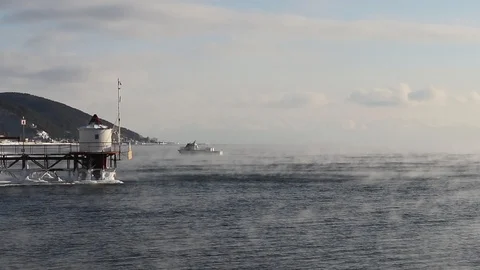 Ship sails on the lake Baikal floating from frost in January Stock Footage 100756813