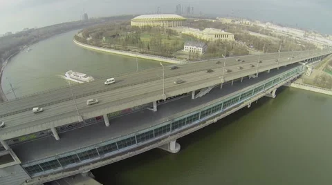Ship sails by river near metro bridge with car traffic Stock Footage 40180052