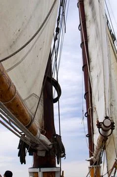 Ship sails seen from below. Sailing boat, blue sky Stock Photos