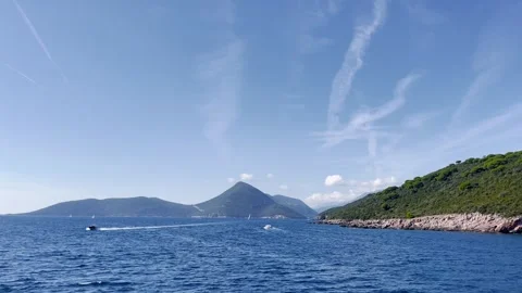 A ship sails through the Mediterranean Sea to the entrance of the Boko Kotor Bay Stock Footage 256306031