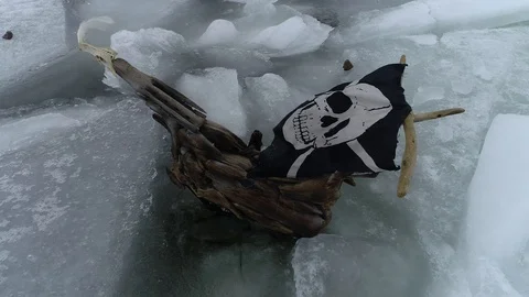 The ship sails through the sea ice in the winter. child pirate ship in ice. Stock Footage 87858448