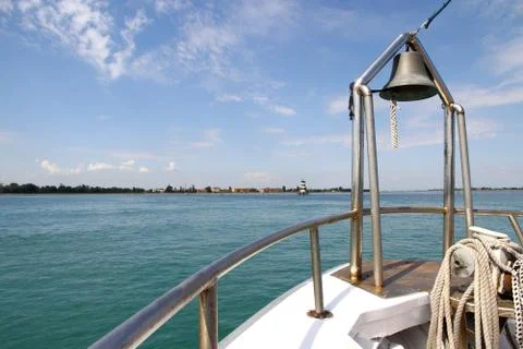 Ship at sea with view of lighthouse deck and bell Stock Photos
