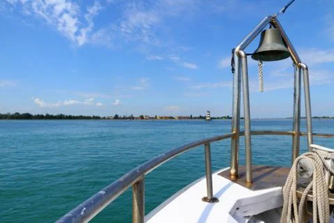 Ship at sea with view of lighthouse deck and bell Stock Photos