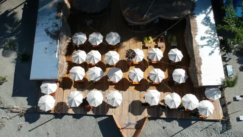 A ship-shaped cafe filled with white umbrellas on the beach Video stock 235372614