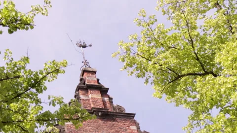 Ship shaped wind vane on stepgable Stock Footage 142480593