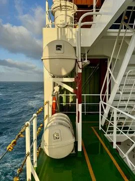 Ship Side Deck with Liferaft Container and Ocean View Stock Photos