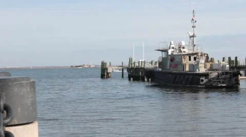 Ship sitting next to dock in ocean Stock Footage 45580445