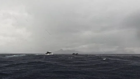 The ship small motor boat sails in a storm, raindrops falling. Diving expedition Stock Footage 257888981