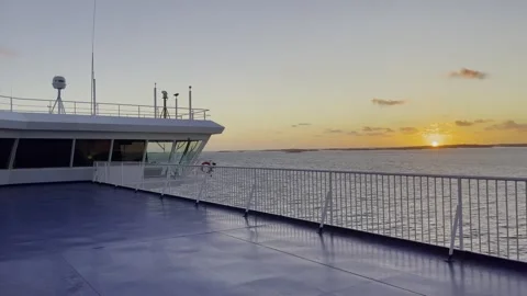 Ship with steering bridge on the sea at sunset near Norway with empty deck Stock Footage 256622906