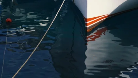 Ship stem with reflection in the mediterranean sea on a wharf. Close-up Stock Footage 118546897