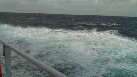 Ship in storm. High waves and splashes along side. White foam on sea. Deck Stock Footage 244605337
