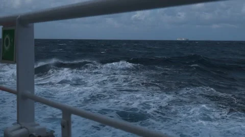Ship in storm. High waves and splashes along side. White foam on sea. Deck Stock Footage 260228167