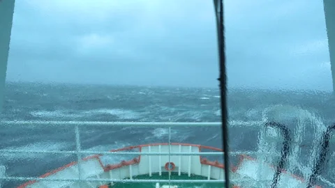 Ship in storm. A lot of splashes. View from bridge. Ship climb up wave. Strong Stock Footage 165366614