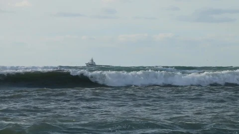 Ship at storm wind in the sea. Strong wind lifts the water drop Stock Footage 99698565