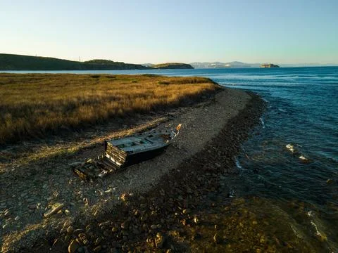 A ship stranded washed by waves near the shore footage taken from the air on Foto stock