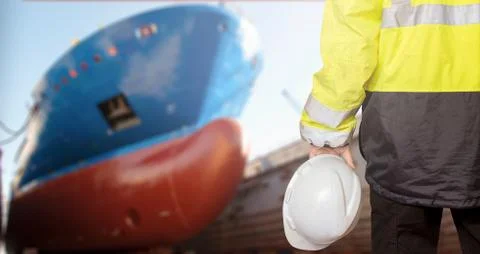 Ship sub-designer or shipbuilder in drydock with ships bow on a background. S Stock-Fotos