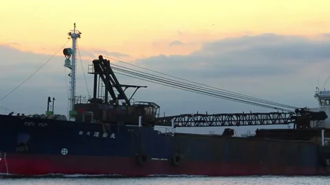Ship sunset passing by ocean shore bay crane on board port harbour Video stock 145731377