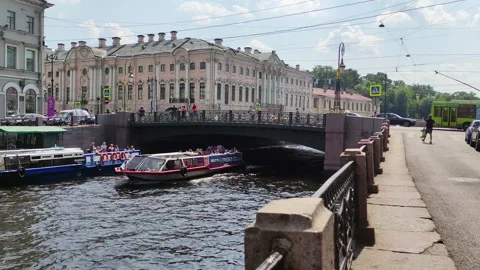 A ship with tourists floats down the river under the bridge. St. Petersburg Stock Footage 157388959