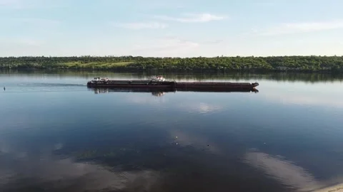 Ship tows cargo along the river Stock Footage 131781850