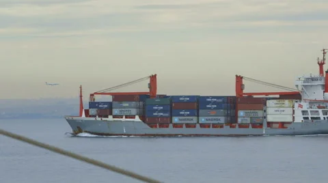 The ship transporting the cargo. The plane is flying at the airport. Stock Footage 68578634