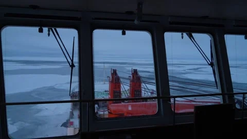 Ship. View from navigation bridge. Frozen sea outside. Cranes on bow of vessel Stock Footage 243386037