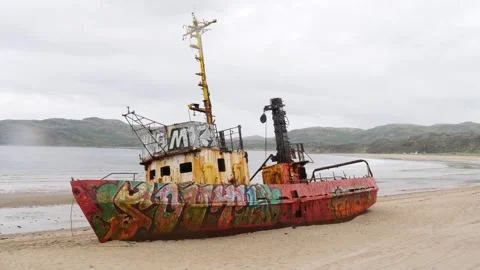 Ship washed up on a sandy beach. Barents Sea, cloudy summer day. Stock Footage 344602031