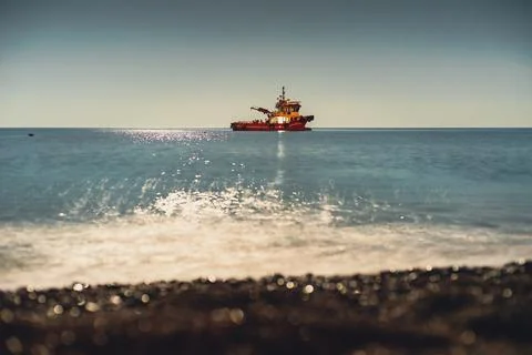 Ship on waves of Mediterranean in Night Harbor Chirali, Turkey. Stock Photos