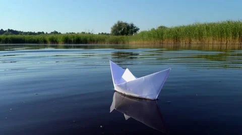 Ship of white paper floating in the river Stock Footage 66366583