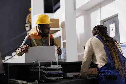 Shipment manager waiting for parcel electronic invoice at reception Stock Photos