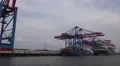 Shipping along the dockside with big container ship in Hamburg harbour HD Footage