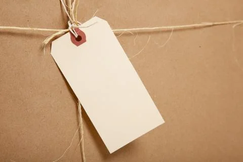 A shipping box ties with string with a blank label Stock Photos