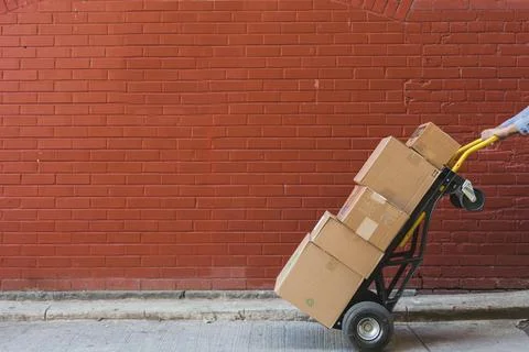 Shipping Boxes In Front Of Red Brick Stock Photos