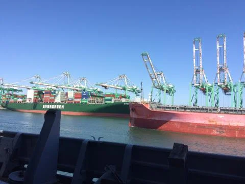 Shipping container cranes for loading ocean cargo ship vessel Stock Photos