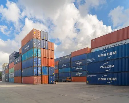 Shipping container site loading by crane in logistic port warehouse storage f 写真素材