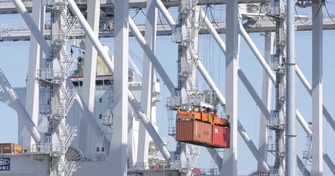 Shipping Containers Being Lifted Through Pylons Stock Footage 129217717
