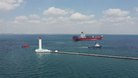 Shipping containers Cargo Vessel passing Lighthouse Stock Footage 138171256