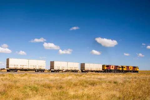 Shipping containers on the move by train Stock Photos