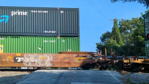 Shipping containers stacked on brown freight train car with graffiti, movin.. Stock Footage 346652025