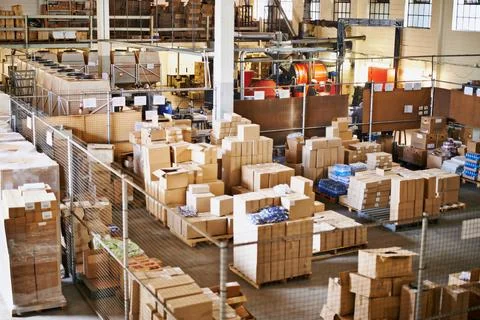 Shipping logistics. Shot of the interior of a large packaging and distribution Stock Photos