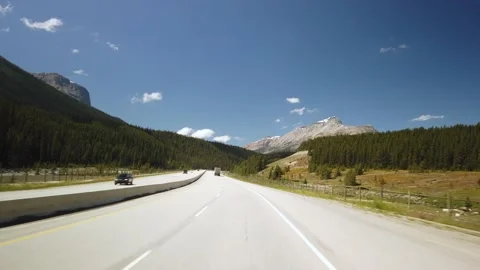 Shipping Train Next to Highway of Yoho National Park Stock Footage 130861889