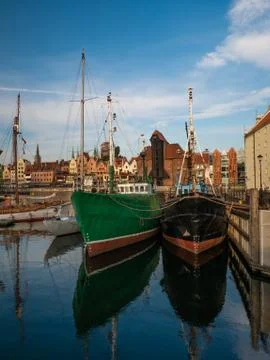 Ships on Motlawa river in Gdansk, Poland and oldest medieval port crane Stock Photos