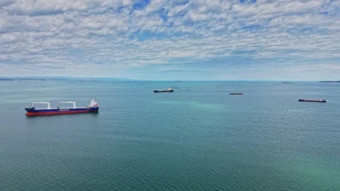 Ships moving on open water with clouds in bright blue sky Video stock 338328893